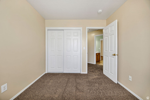 2 West 1780 North Logan, UT 84341 - Photo 19 of 24 Unfurnished bedroom featuring dark carpet and a closet