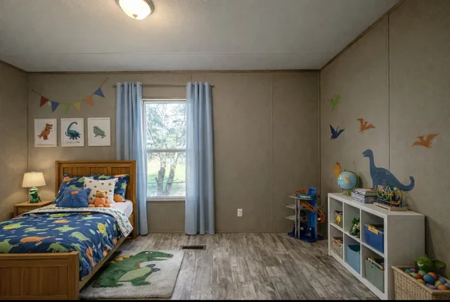 a bedroom with a bed and a window