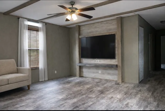 a view of livingroom with furniture window and a ceiling fan