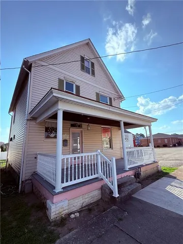a view of a house with a yard and deck
