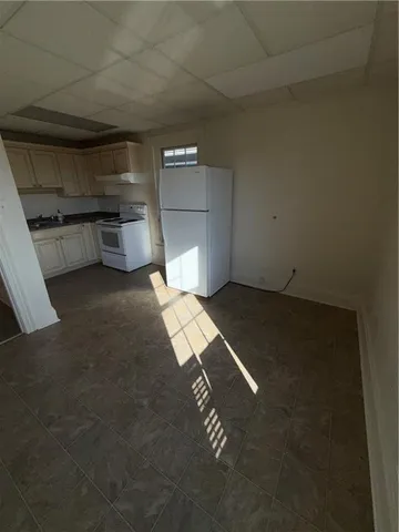 a kitchen with a refrigerator and a stove top oven