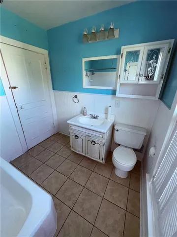 a bathroom with a sink toilet and mirror