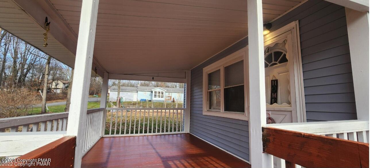 144 Louise Lane Bartonsville, PA 18321 - Photo 2 of 8 a view of a porch with wooden floor and outdoor space