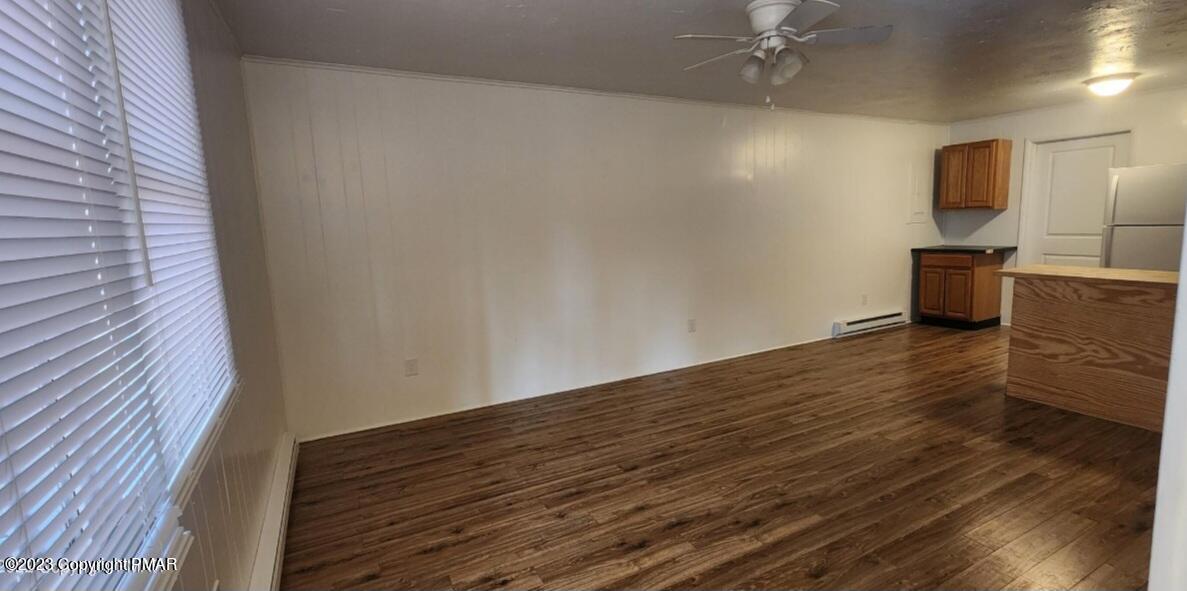 144 Louise Lane Bartonsville, PA 18321 - Photo 6 of 8 a view of a livingroom with wooden floor and a ceiling fan