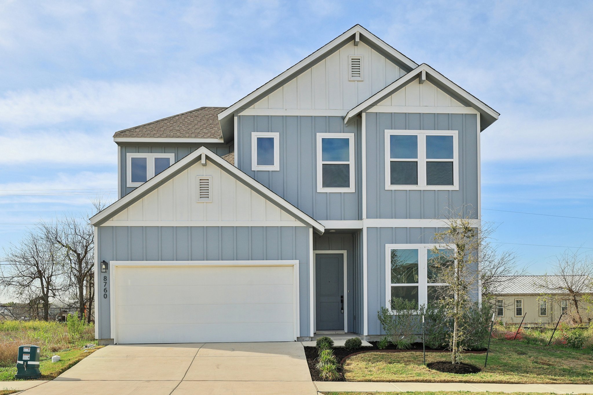 Craftsman inspired home with board and batten siding, concrete driveway, a garage, and a shingled roof