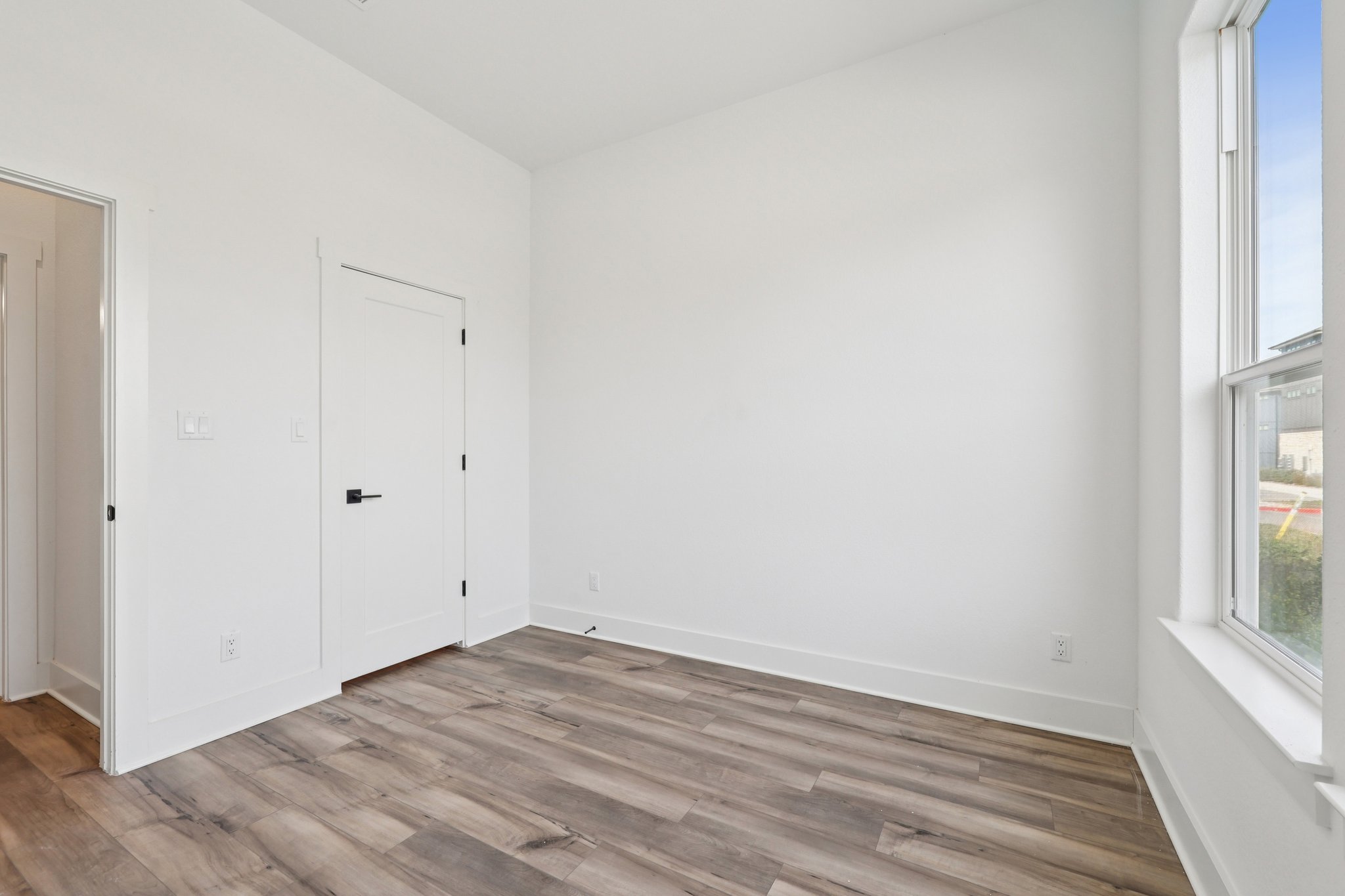 8760 Wellspring Loop Hutto, TX 78634 - Photo 16 of 37 Unfurnished bedroom with light wood-style flooring and baseboards