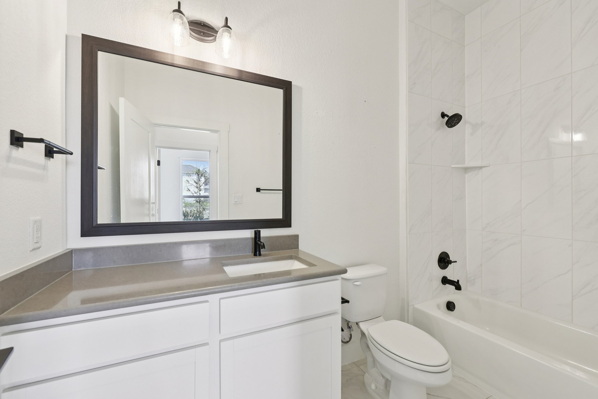 8760 Wellspring Loop Hutto, TX 78634 - Photo 17 of 37 Full bathroom featuring vanity and tub / shower combination
