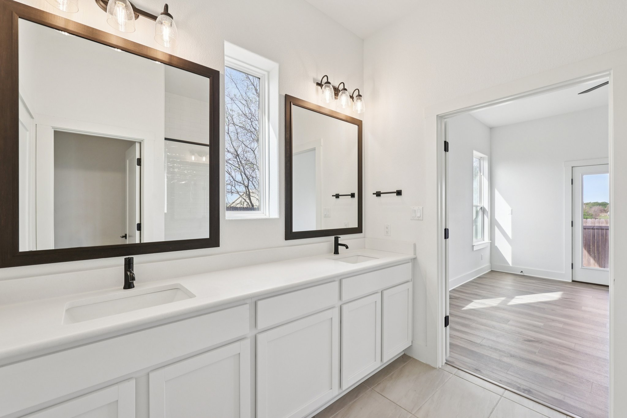 8760 Wellspring Loop Hutto, TX 78634 - Photo 24 of 37 Bathroom featuring double vanity, plenty of natural light, and light tile patterned floors