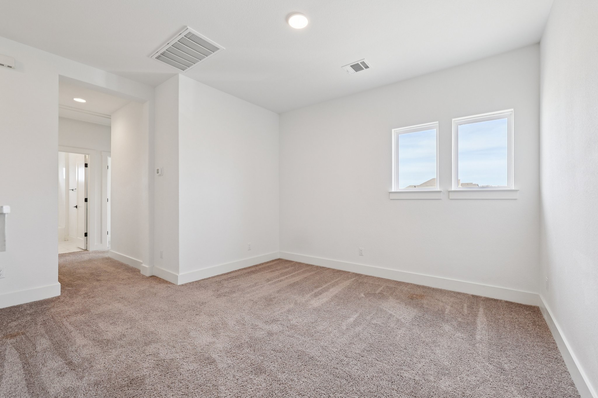 8760 Wellspring Loop Hutto, TX 78634 - Photo 26 of 37 Unfurnished room with light colored carpet and recessed lighting