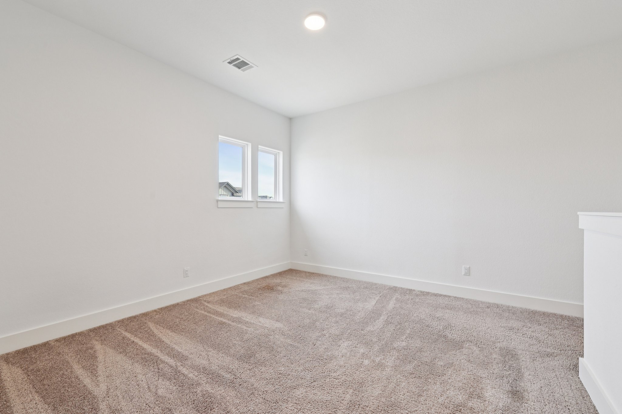 8760 Wellspring Loop Hutto, TX 78634 - Photo 27 of 37 Unfurnished room with light carpet and recessed lighting