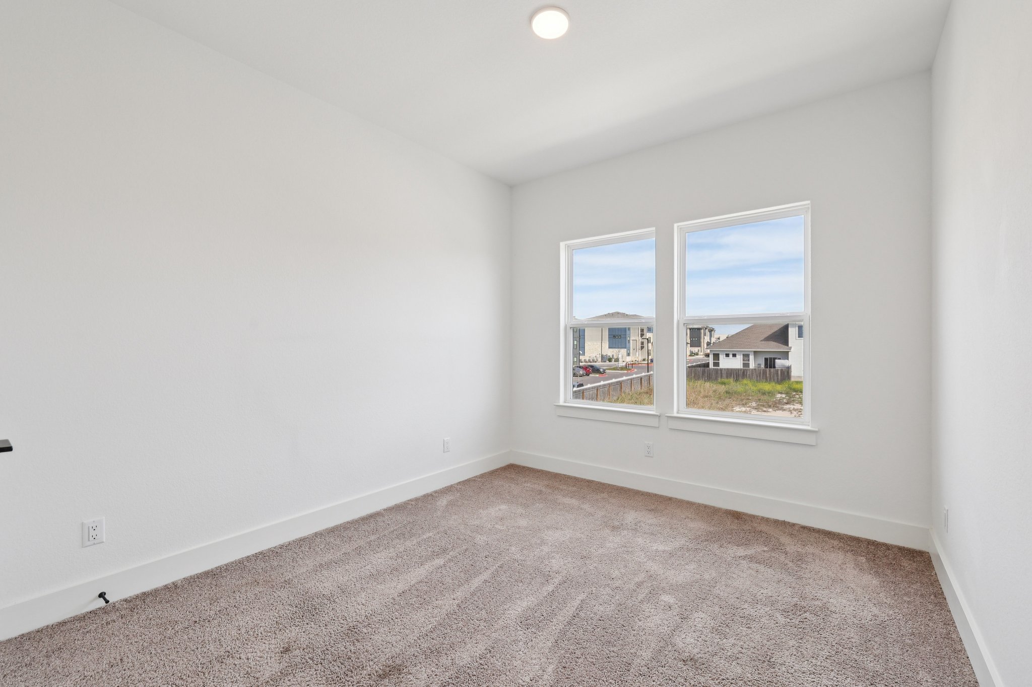 8760 Wellspring Loop Hutto, TX 78634 - Photo 29 of 37 Spare room with light colored carpet and baseboards