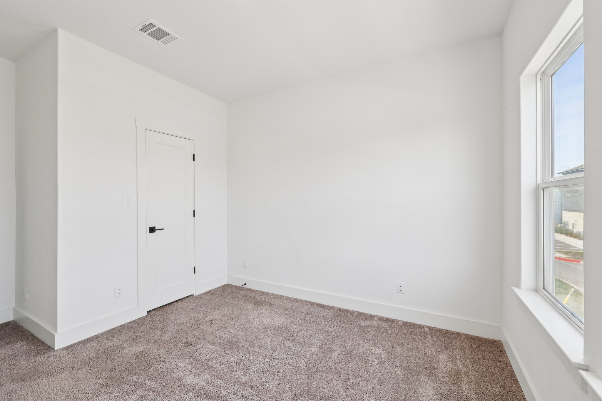 8760 Wellspring Loop Hutto, TX 78634 - Photo 30 of 37 Spare room with carpet flooring and healthy amount of natural light
