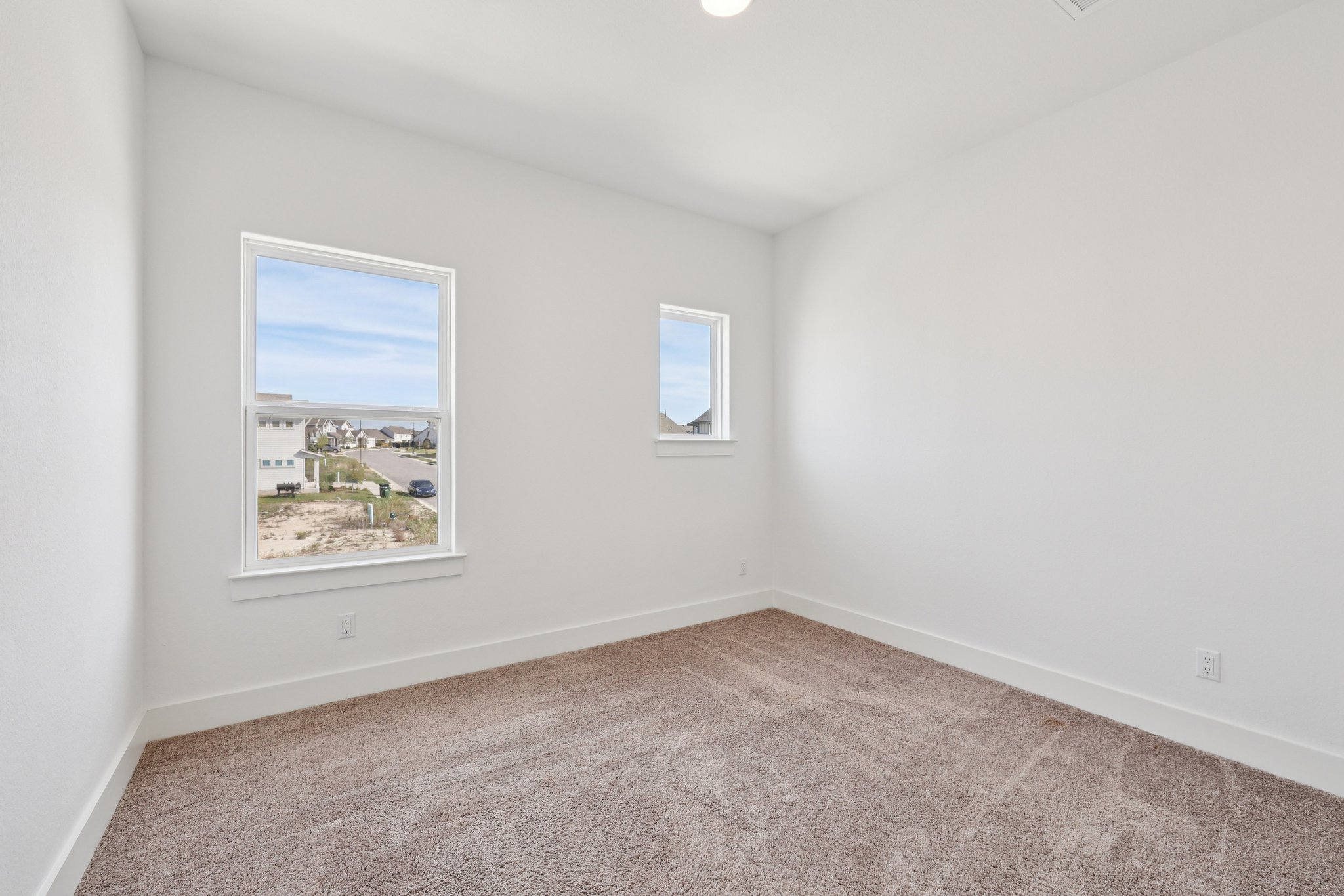 8760 Wellspring Loop Hutto, TX 78634 - Photo 31 of 37 Empty room featuring light colored carpet and baseboards