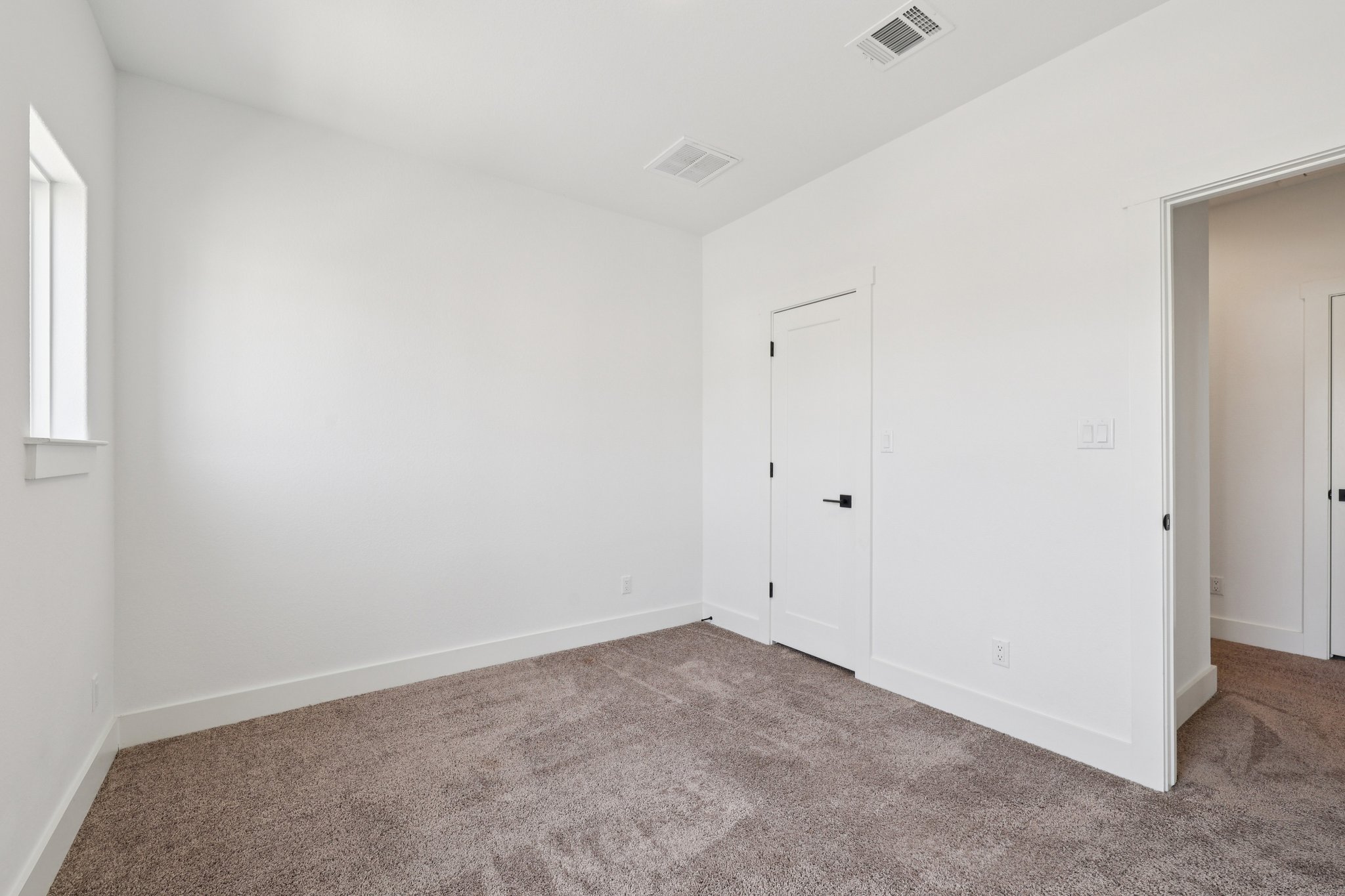 8760 Wellspring Loop Hutto, TX 78634 - Photo 32 of 37 Unfurnished bedroom featuring carpet and baseboards