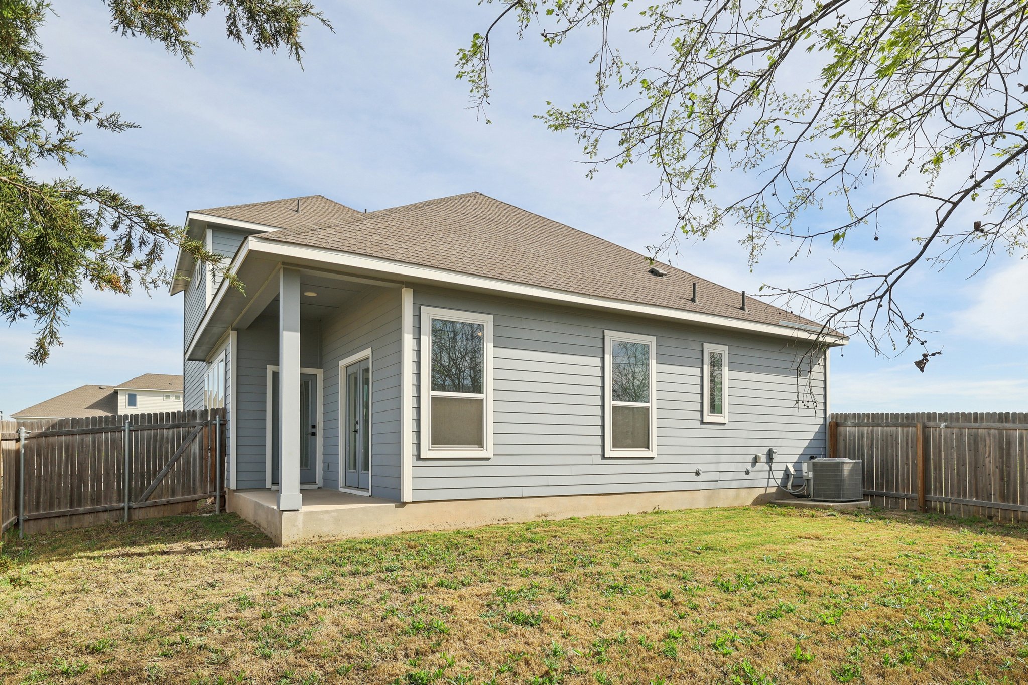 8760 Wellspring Loop Hutto, TX 78634 - Photo 34 of 37 Rear view of house featuring a patio area, a fenced backyard, and roof with shingles