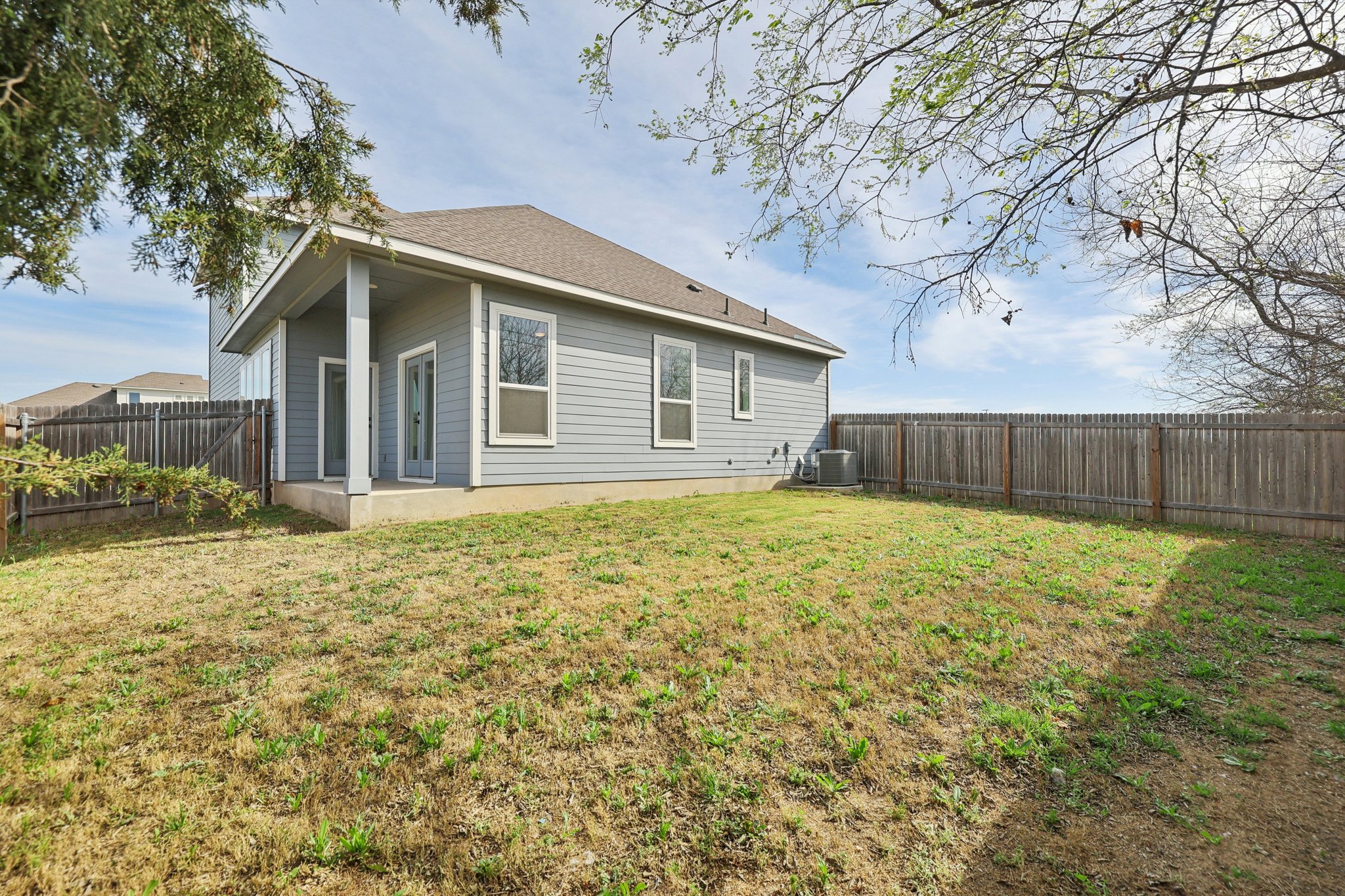 8760 Wellspring Loop Hutto, TX 78634 - Photo 35 of 37 Rear view of property with a fenced backyard, a patio, and roof with shingles
