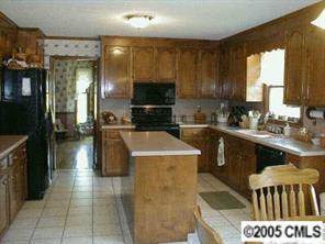 223 Campsite Road Rock Hill, SC 29732 - Photo 2 of 6 a kitchen with a sink a stove top oven a refrigerator and a cabinets
