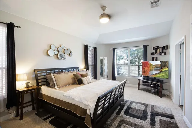 a bedroom with a bed and a desk