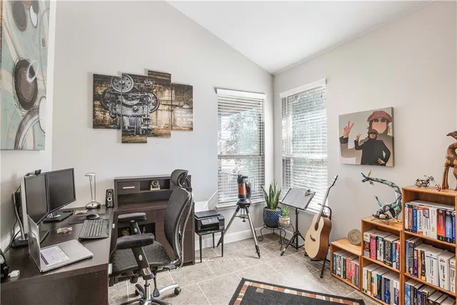 a view of a workspace with a window and lounge chair