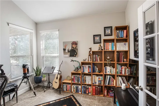 a living room with lots of furniture and a book shelf