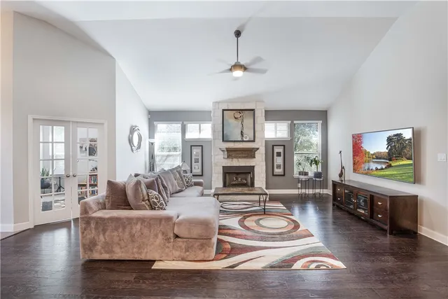 a living room with fireplace furniture and a wooden floor
