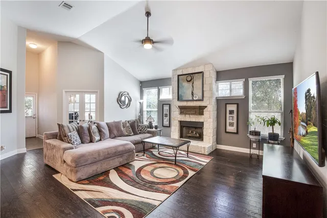 a living room with fireplace furniture and a flat screen tv