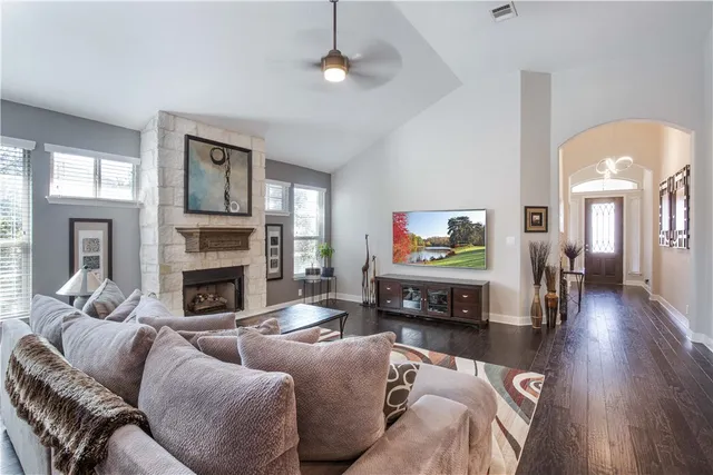 a living room with furniture a fireplace and a flat screen tv