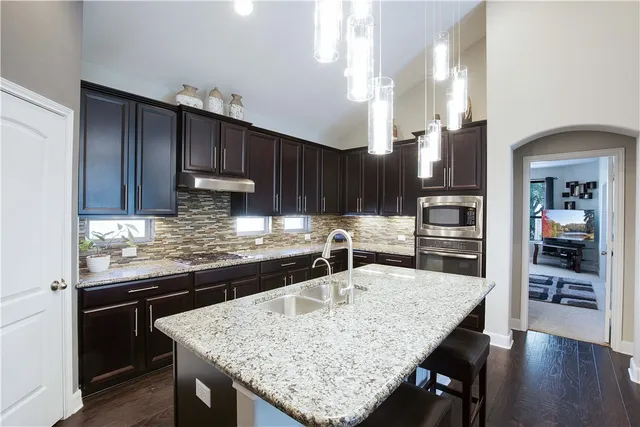 a kitchen with center island and stainless steel appliances