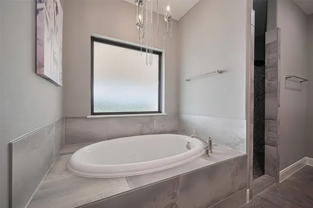 a white bath tub sitting next to a white sink