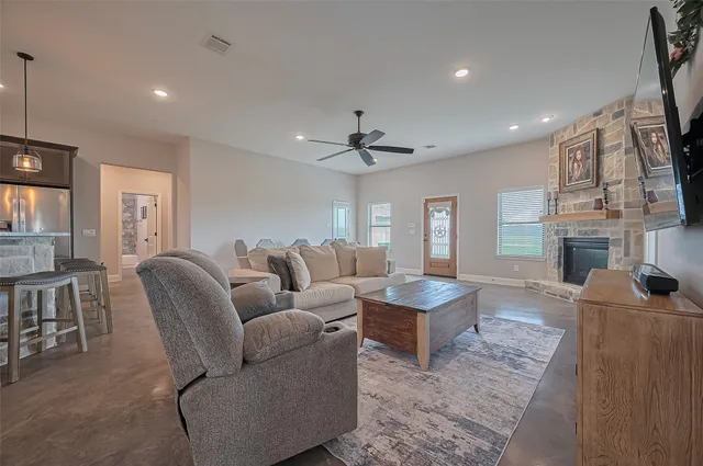 a living room with furniture and a fireplace
