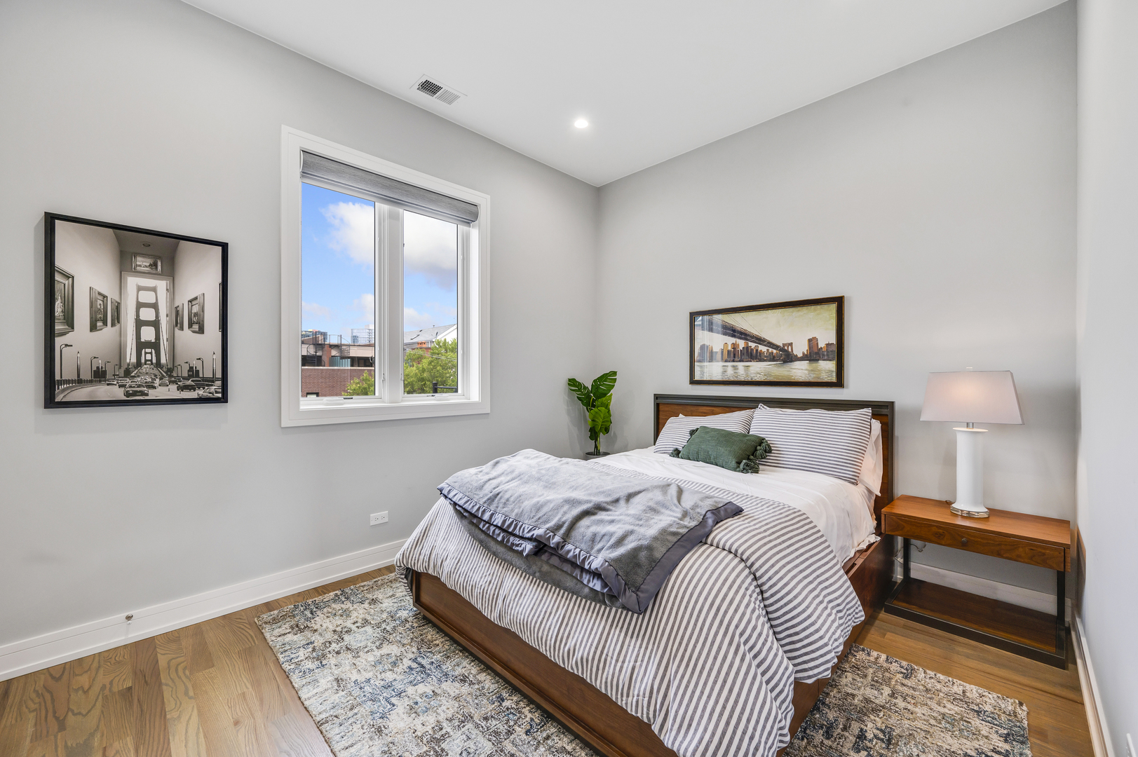 1310 North Cleveland Avenue, Unit 3 Chicago, IL 60610 - Photo 14 of 22 a bedroom with a bed and a painting on the wall