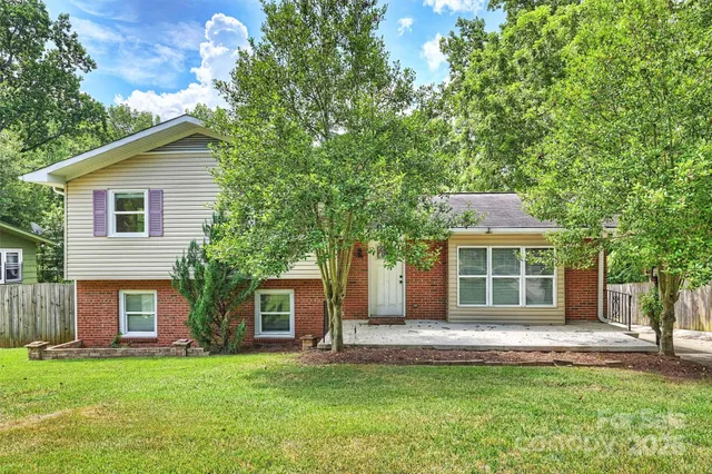 a front view of a house with a garden and yard