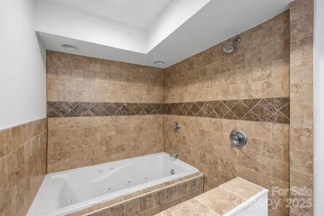 a bathroom with a bathtub and shower