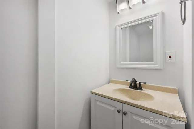 a bathroom with a sink and vanity