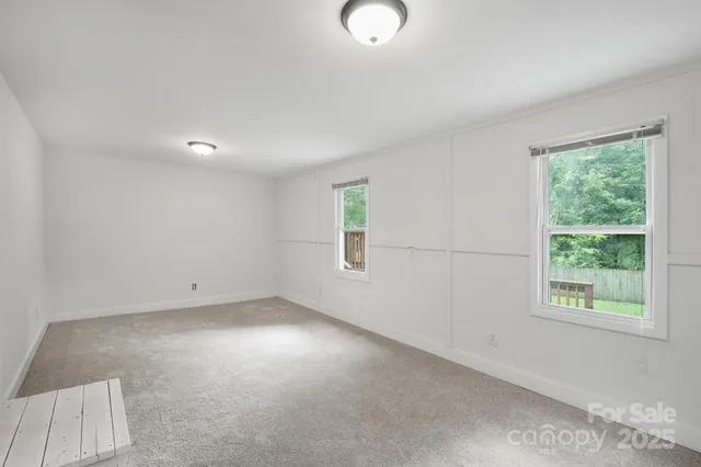 an empty room with windows and entrance