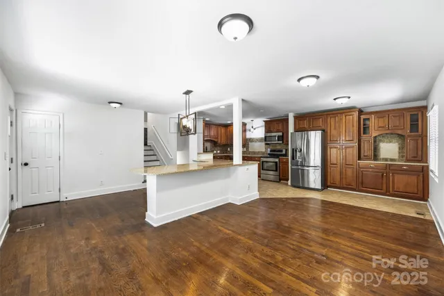 a view of a kitchen with a sink stove and cabinets