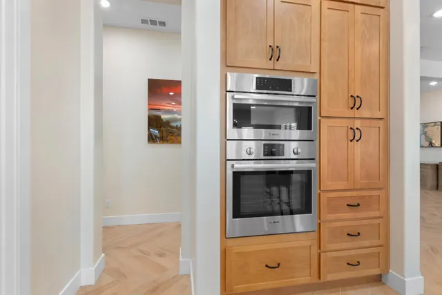 a kitchen with stainless steel appliances granite countertop a sink a stove and cabinets
