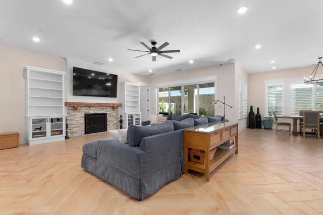 a living room with furniture a fireplace and a flat screen tv