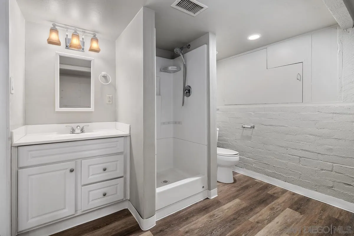 4744 Resmar Road La Mesa, CA 91941 - Photo 21 of 58 a bathroom with a granite countertop sink a toilet and shower