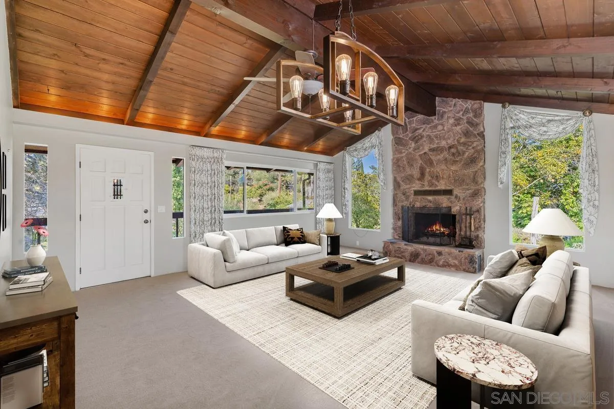 4744 Resmar Road La Mesa, CA 91941 - Photo 8 of 58 a living room with furniture a fireplace and a large window