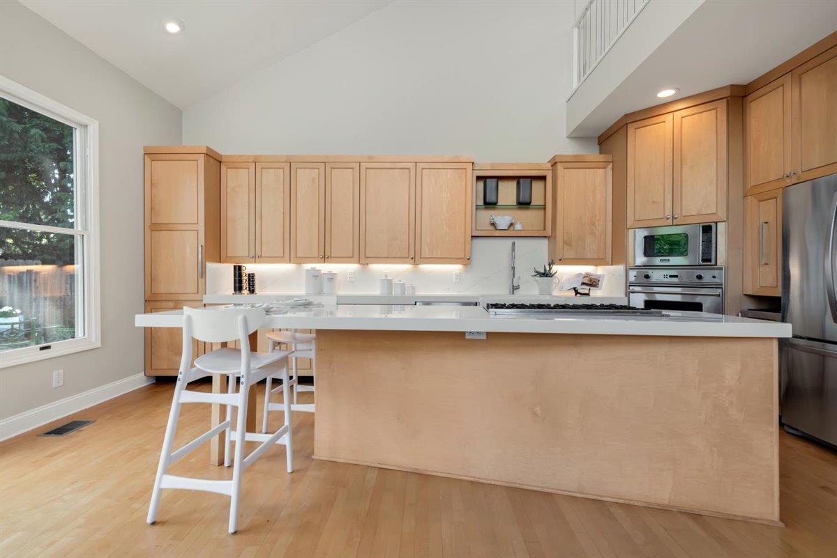 1825 West Middlefield Road Mountain View, CA 94043 - Photo 13 of 42 a kitchen with stainless steel appliances granite countertop a stove top oven a sink a dining table and chairs
