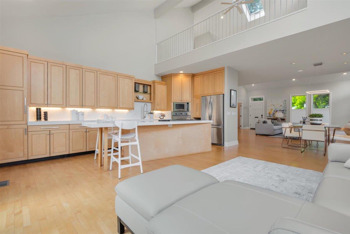 1825 West Middlefield Road Mountain View, CA 94043 - Photo 16 of 42 a kitchen with kitchen island a stove a refrigerator a sink dishwasher with a dining table and chairs with wooden floor
