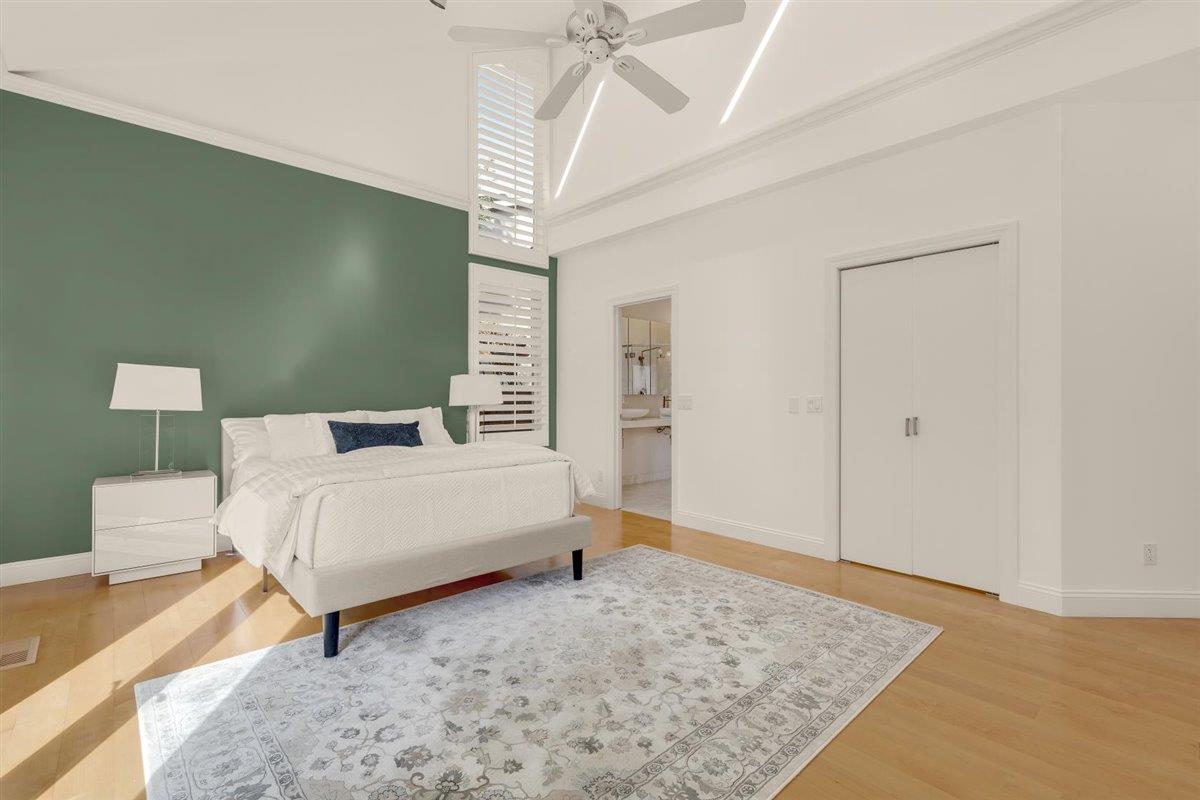 1825 West Middlefield Road Mountain View, CA 94043 - Photo 22 of 42 a bedroom with a bed and a chandelier