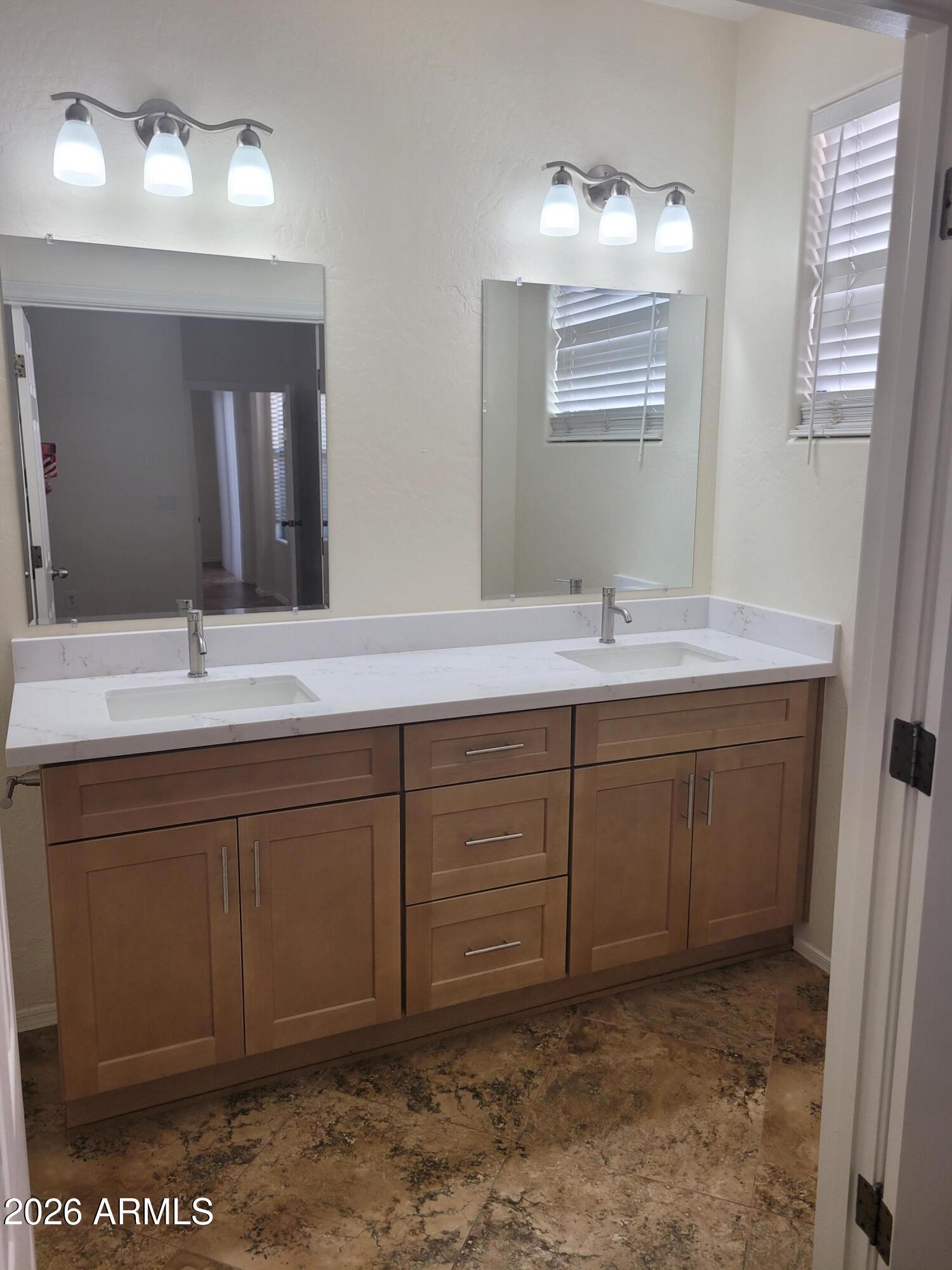 1453 South Sinova Avenue Gilbert, AZ 85296 - Photo 24 of 46 a bathroom with a sink and a mirror