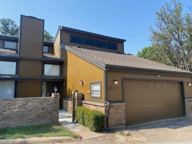 a front view of a house with garage