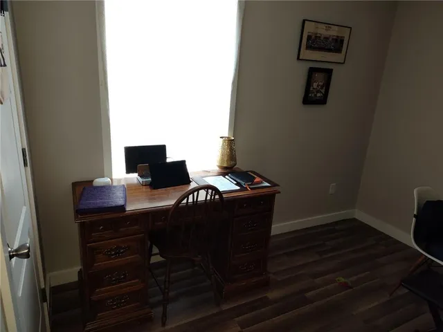 a workspace with furniture and wooden floor