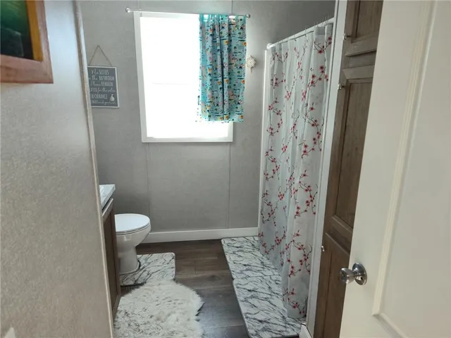 a bathroom with a toilet and a shower