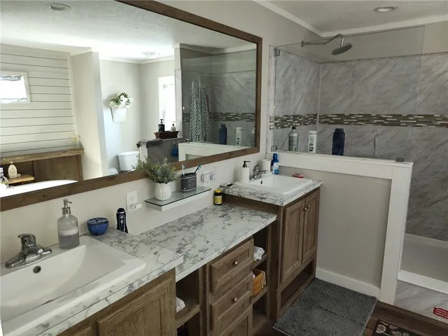 a bathroom with a granite countertop sink and a mirror