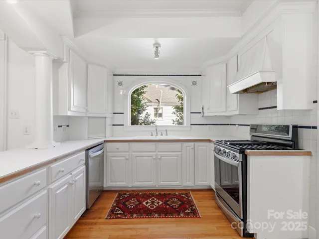 a kitchen with stainless steel appliances granite countertop a stove a sink and a granite counter tops
