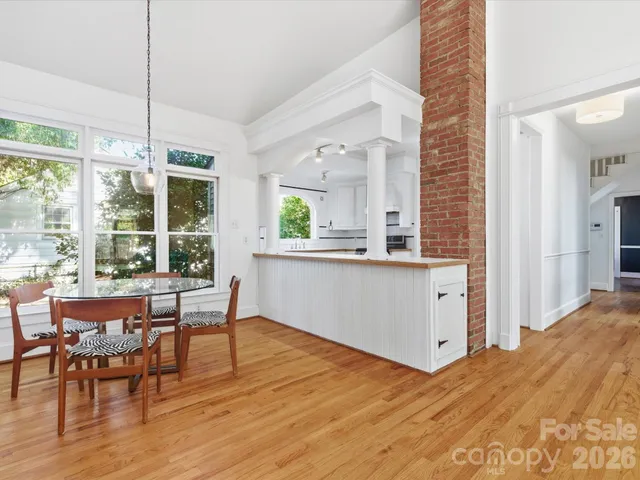 a view of a dining room with furniture window and wooden floor